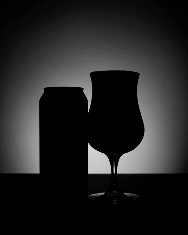 Dark and moody product video of a black IPA beer with a spotlight turning on and off