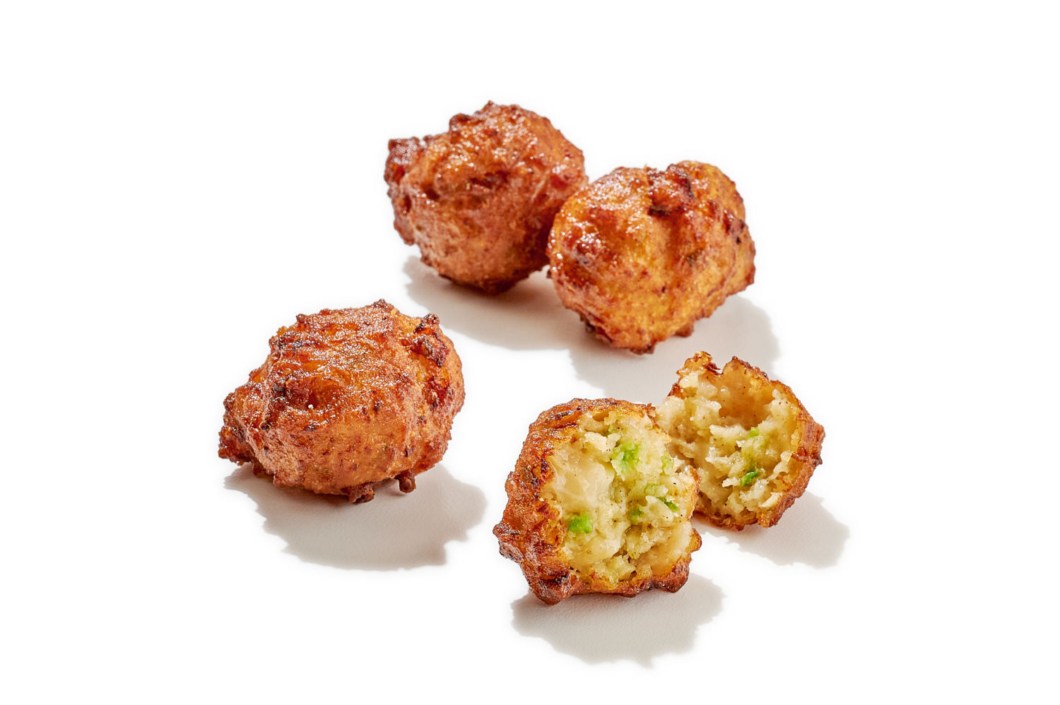 Food photography conch fritters on white background